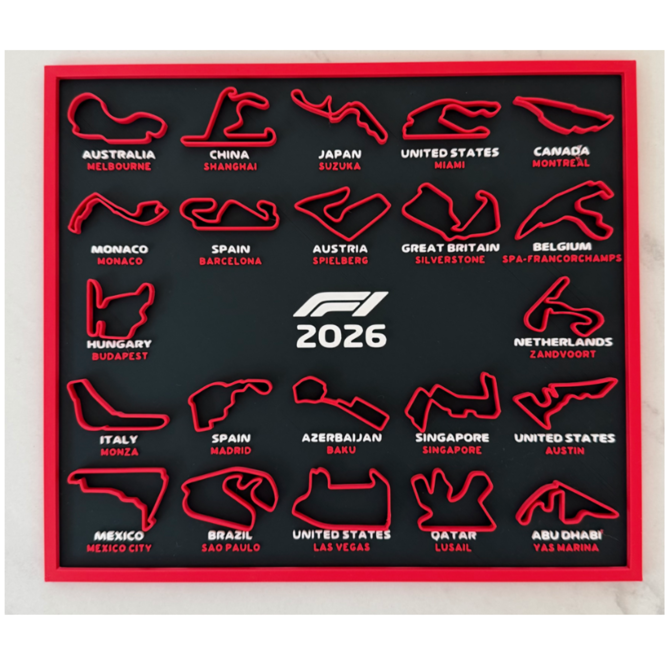 Map of Formula 1 race tracks with track shapes and names on a black background