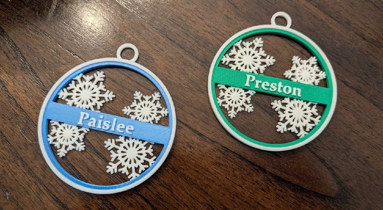 Pink custom Christmas snowflake ornament hanging on Christmas tree