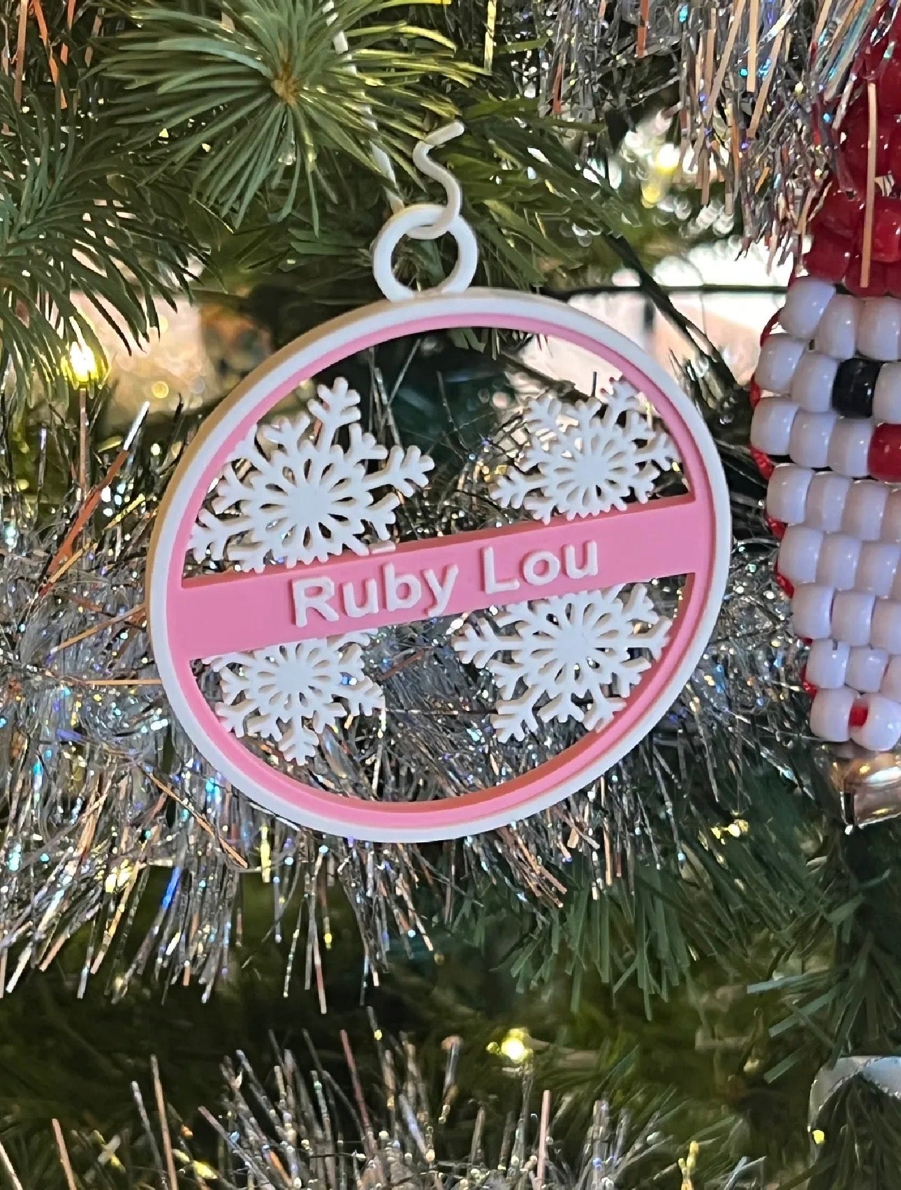Personalized Christmas ornament with snowflakes and custom name, red and white design