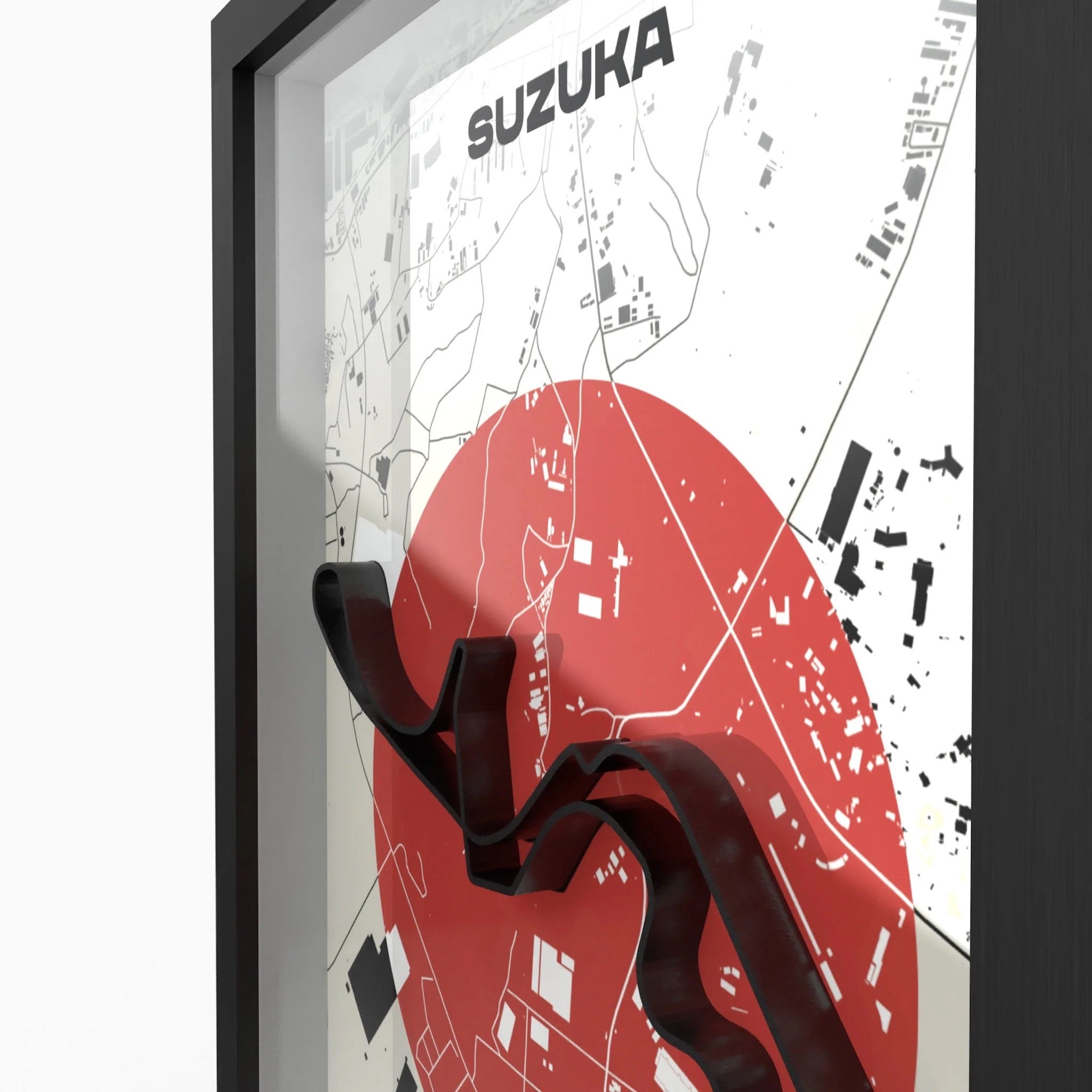 Framed Suzuka city map wall art with a large red circle, black street details, and a black frame shown at an angle against a light background.
Suzuka Formula 1 track framed 3D wall art front view premium A4