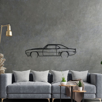 Living room with a gray sofa, decorative lamp, and car wall decal on a gray wall.