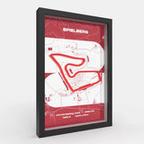 A framed minimalist circuit map print of Spielberg race track, featuring a red track line and red header with the word 'SPIELBERG' on a white background, enclosed in a black frame.
Side profile Red Bull Ring track artwork showing elevation layers