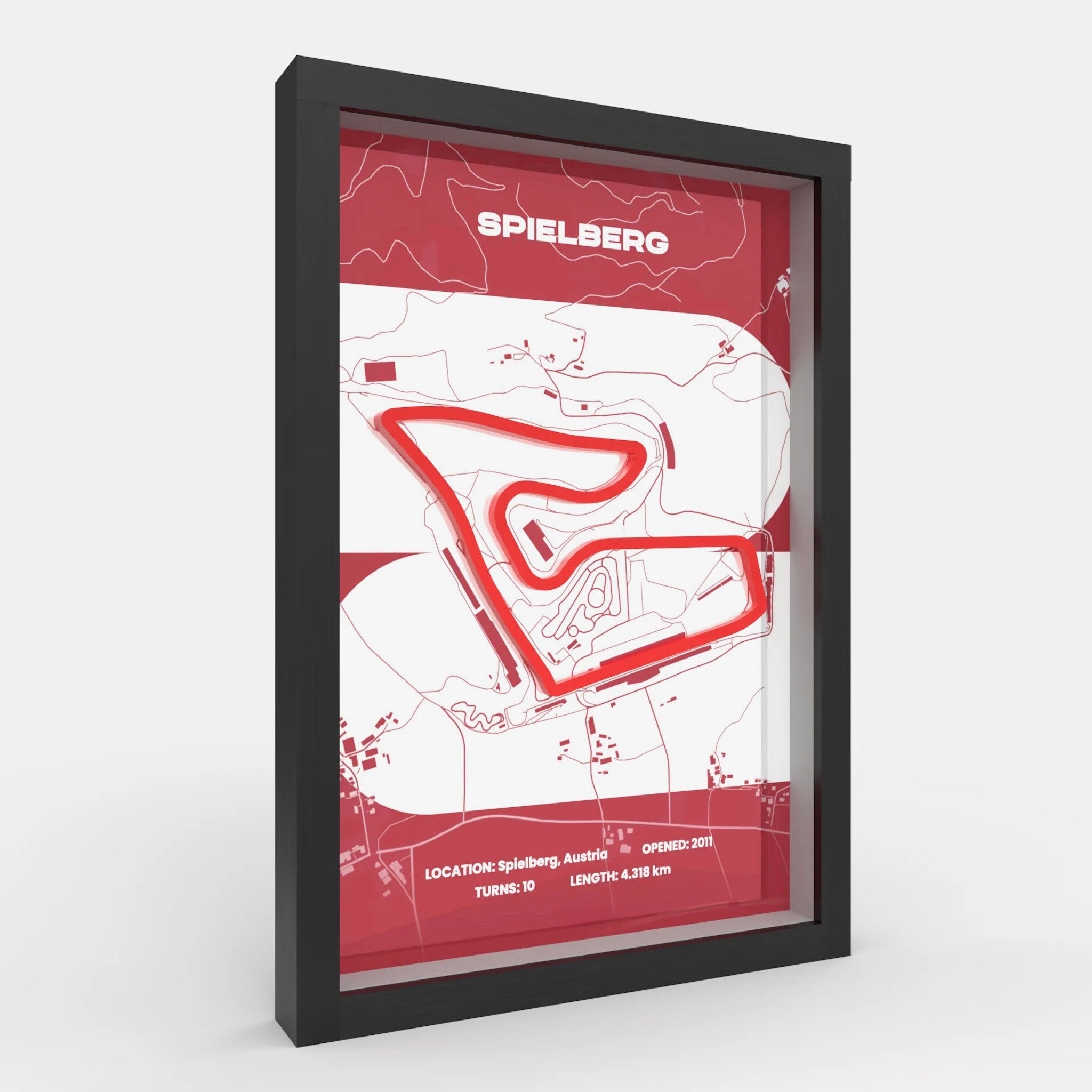 A framed minimalist circuit map print of Spielberg race track, featuring a red track line and red header with the word 'SPIELBERG' on a white background, enclosed in a black frame.
Side profile Red Bull Ring track artwork showing elevation layers