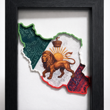 “Iran map 3D wall art in black frame with lion and sun design on a desk”
